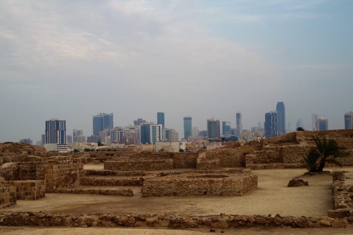 Pre-history meets modernity: Archaeological site in the foreground and the modern buildings of Manama in the far background (December 2015).