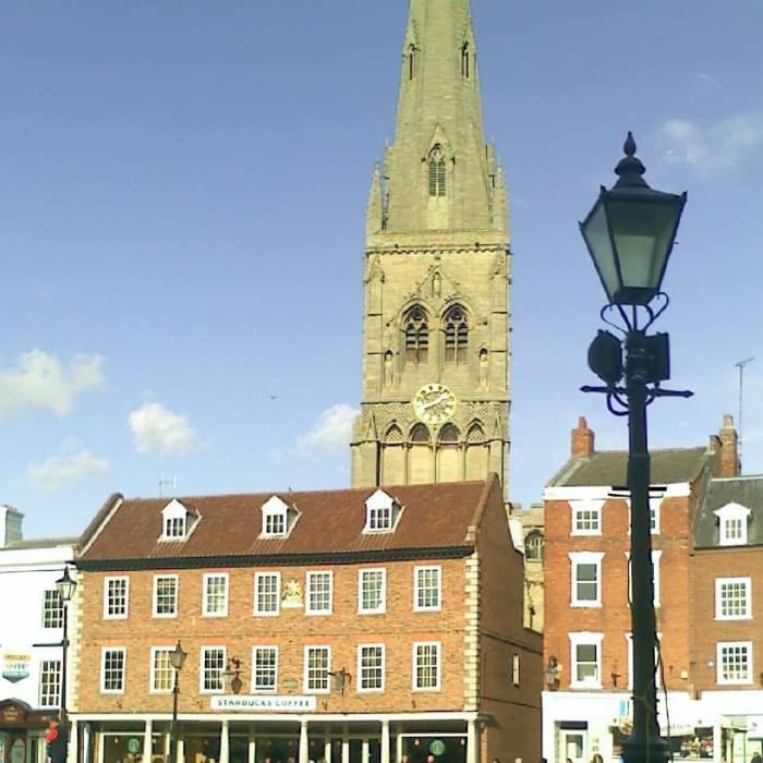 The Church of St. Mary Magdalene, locally known simply as 'the Parish Church', seen from Newark Market Place. The building centre-left is the Moot Hall.