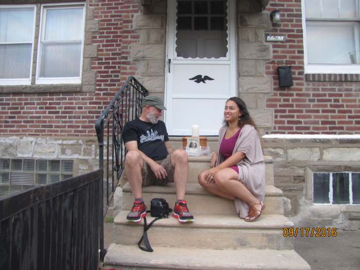 Sitting on the stoop at my mother's house with my daughter. My mother's ashes are in the wooden box next to us with her graduation picture reminding everyone how beautiful she was.