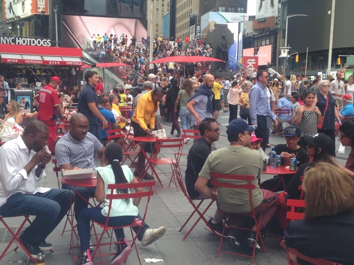 A Typical day at Duffy's Square in the Middle of Times Square where hundreds of thousands of people of all colors and shapes pass by daily.