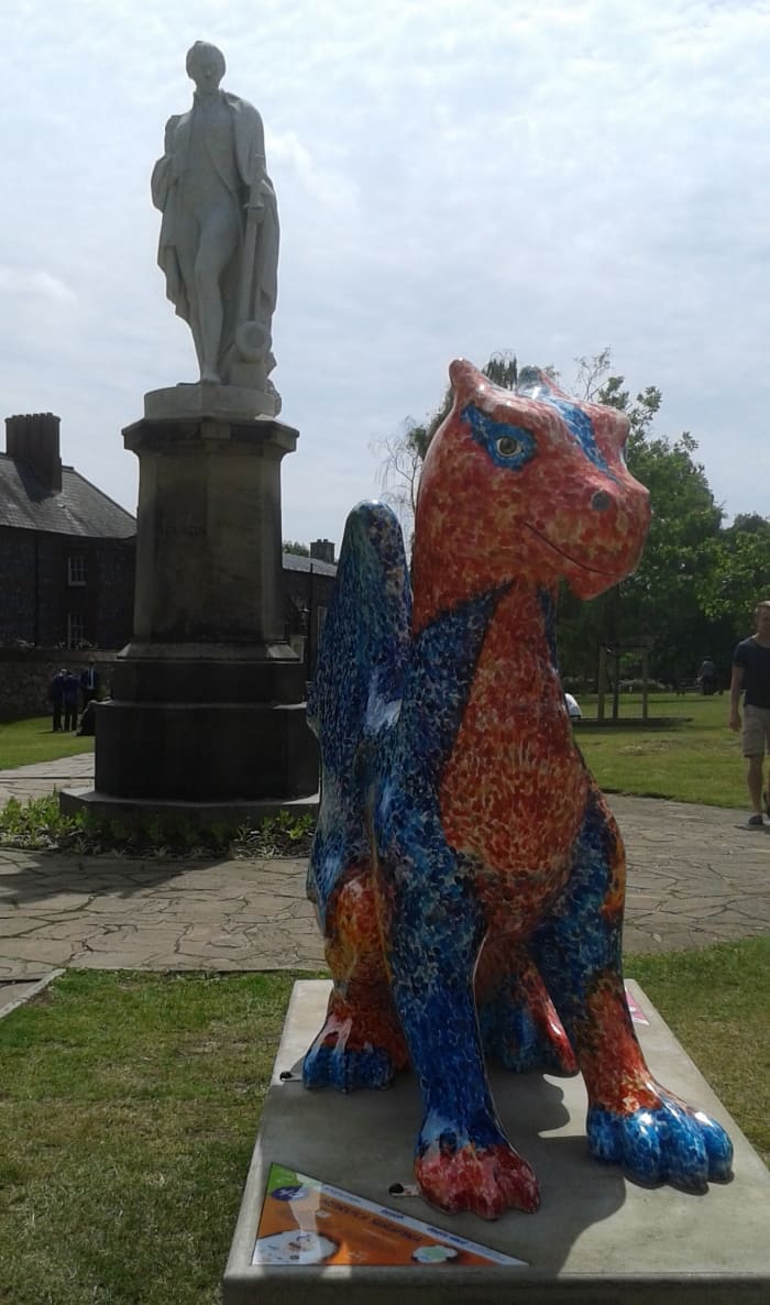 Statue of Admiral Horatio Nelson, guarded by a dragon (or is it the other way round?!), within the verdant close.