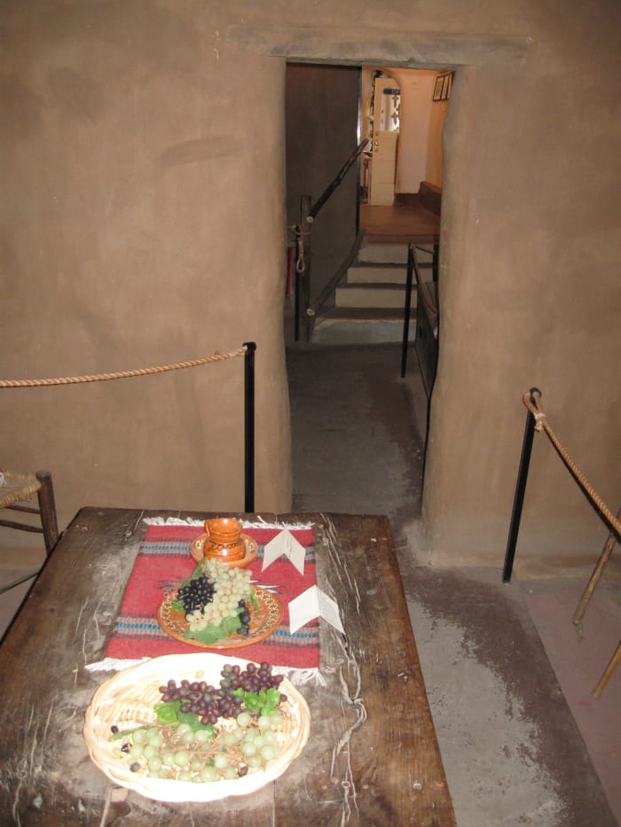 Dinner table with period food inside Santa Fe's Casa Vieja de Analco