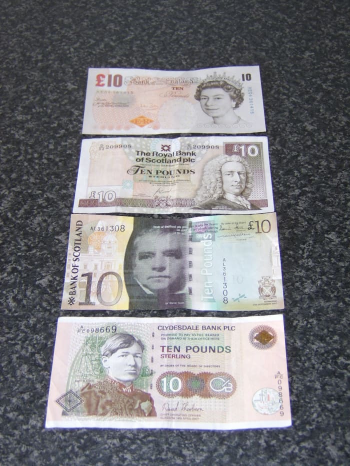 Examples of the different notes you will encounter in Scotland on a daily basis. These are all 10 pound notes and are issued by (from top to bottom) Bank of England, Royal Bank of Scotland, Bank of Scotland and Clydesdale Bank