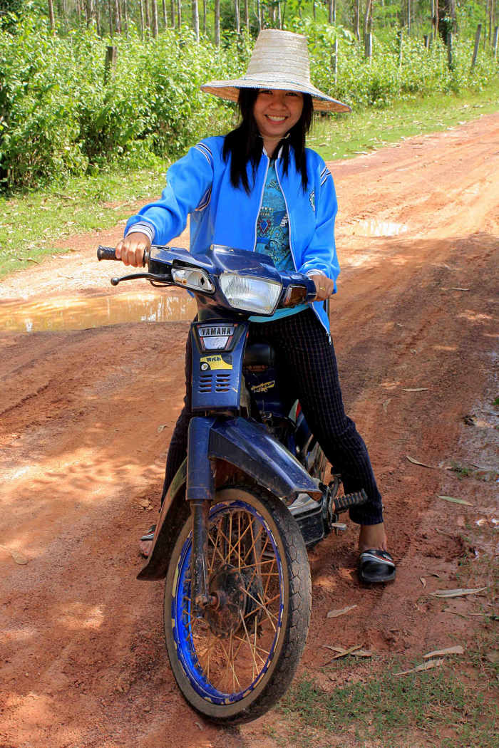 Alisa rides the ubiquitous moped - staple transport in the village. (She also models the characteristic local headgear)
