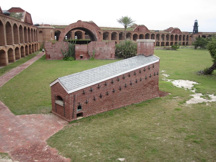 The fully-restored hot-shot furnace, with one of the fort's 37 powder magazines behind it