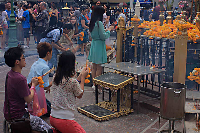 The drawing power of this tiny shrine is apparent as Thais come from the shops and offices around to pray and to make offerings