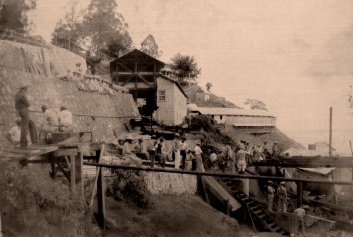 El Rosario mill site. The aftermath of a fire, mill workers, guards with shotguns.