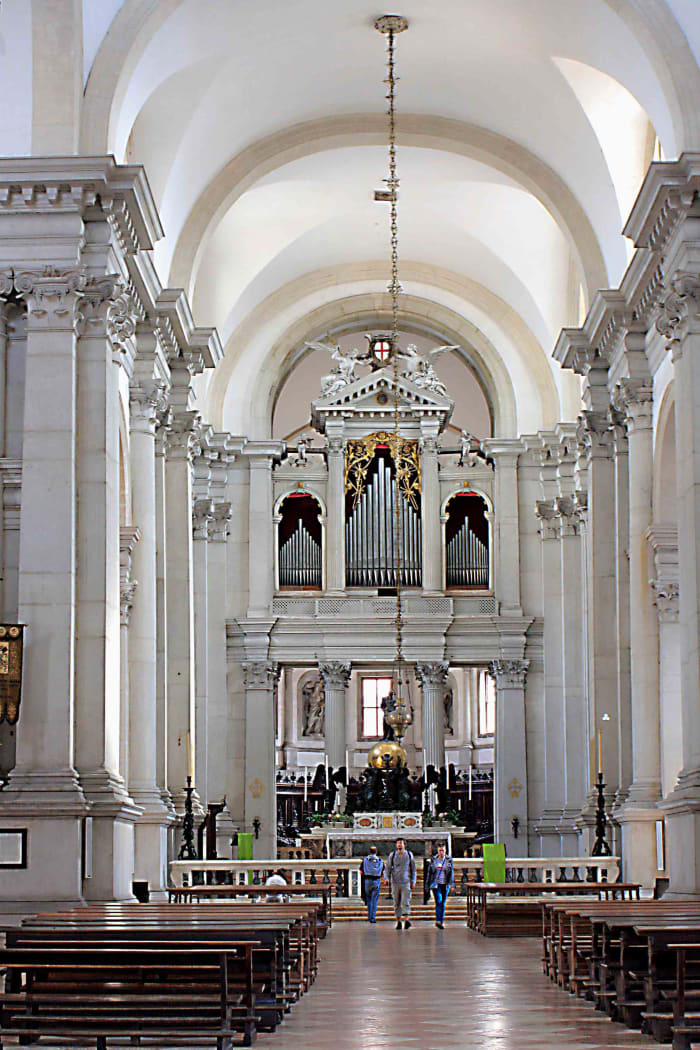 The interior of Palladio's Church which features several major art works by the artist Tintoretto, a 16th century altar sculpture, and carved wooden choir stalls of the same age