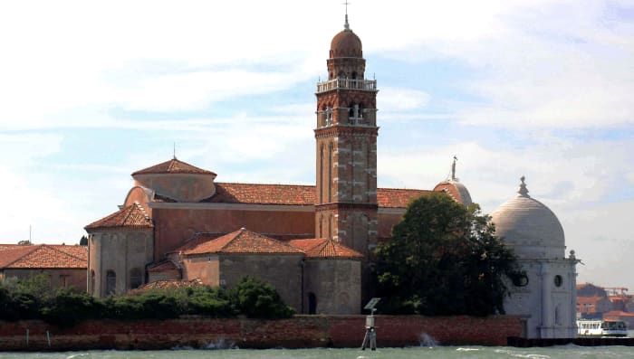 San Michele, as seen from the island of Murano, with a vaporetto - and Venice - on the extreme right. The tantalisaing sight of historic buildings across the lagoon should be enough to encourage anyone to set out and explore these other islands