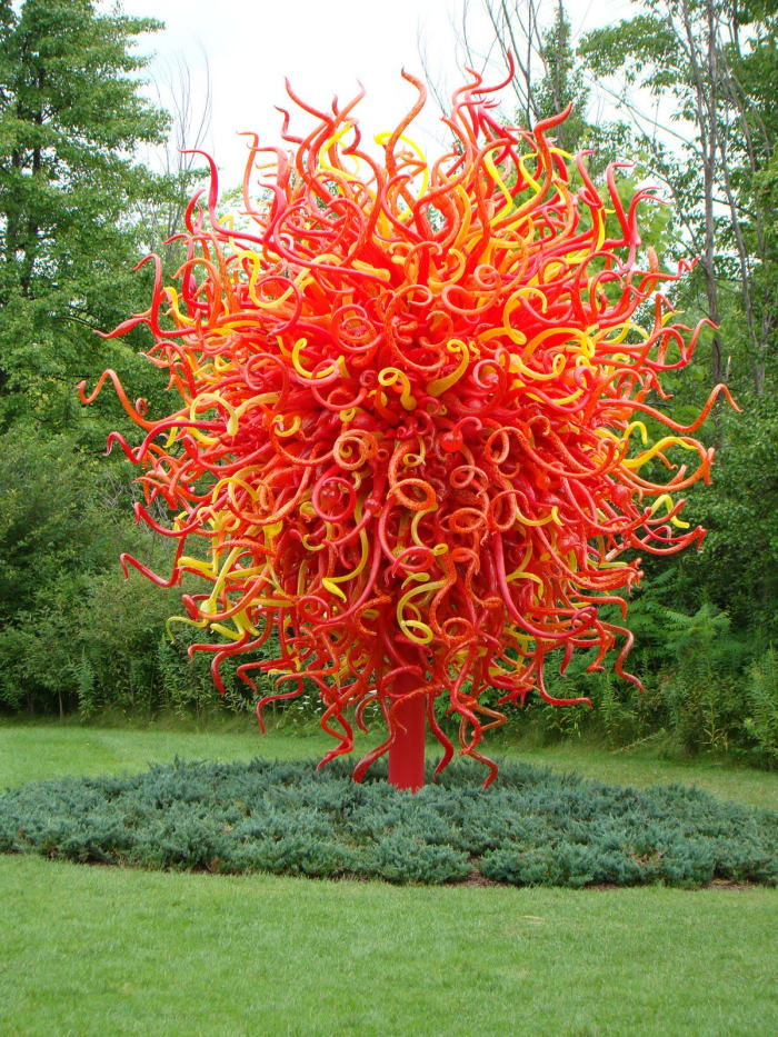 This flowering tree sculpture - "Summer Sun" consists of 2,000 red, yellow, and orange hand-blown elements.