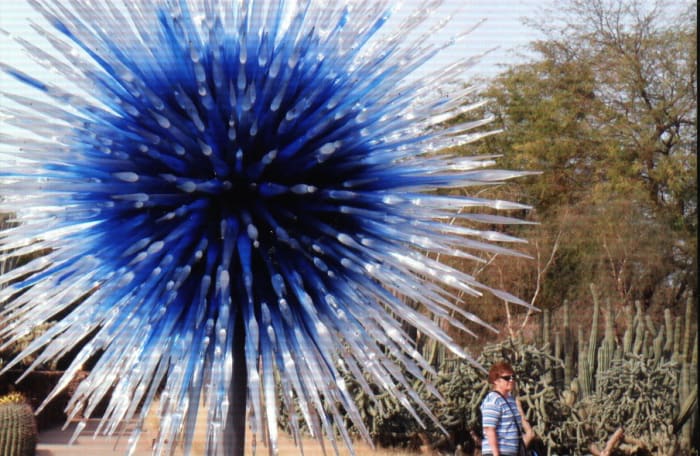 A beautiful sculpture resembling an exploding blue star - "Scarlet and Yellow Asymmetrical Towers" at the entrance to Desert Discovery Loop
