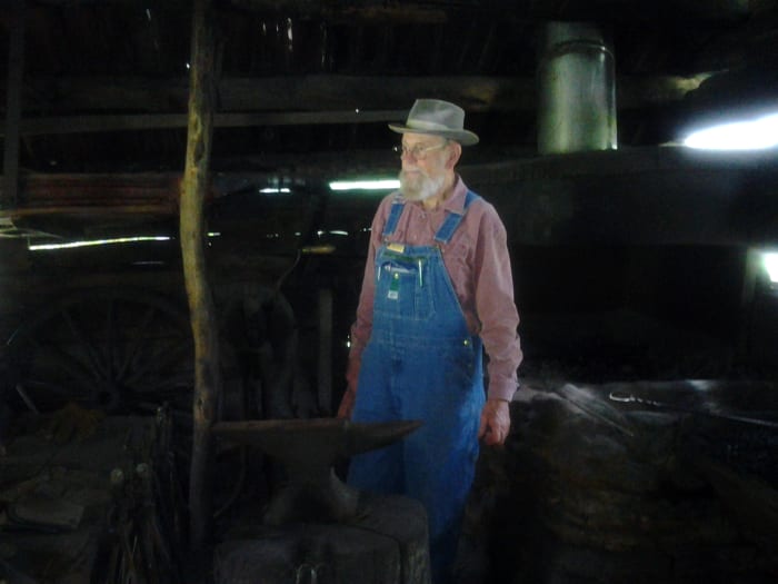Blacksmith Will Foster demonstrates his skills at Mabry Mill. Mr. Foster is a volunteer.