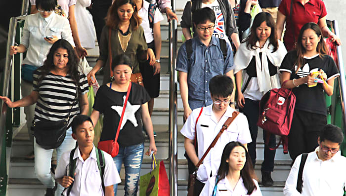 Daily commuting - the Skytrain is one of the most popular transport systems in the city. These commuters and shoppers are descending from a station above the streets