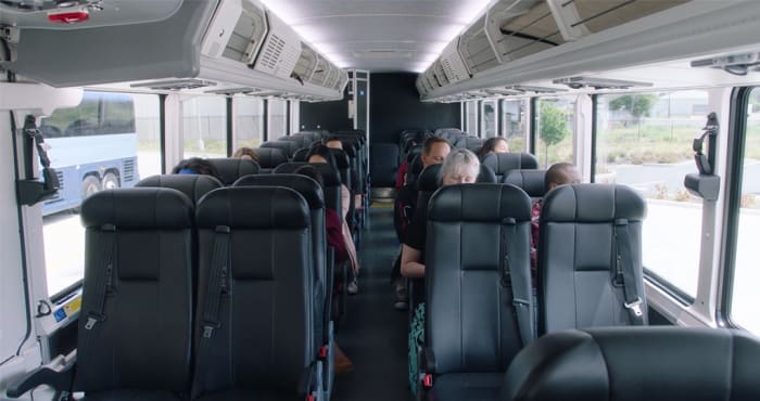 The closer you are to the driver, the farther you are from the smelly bathroom and the less likely you are to encounter problematic passengers.
