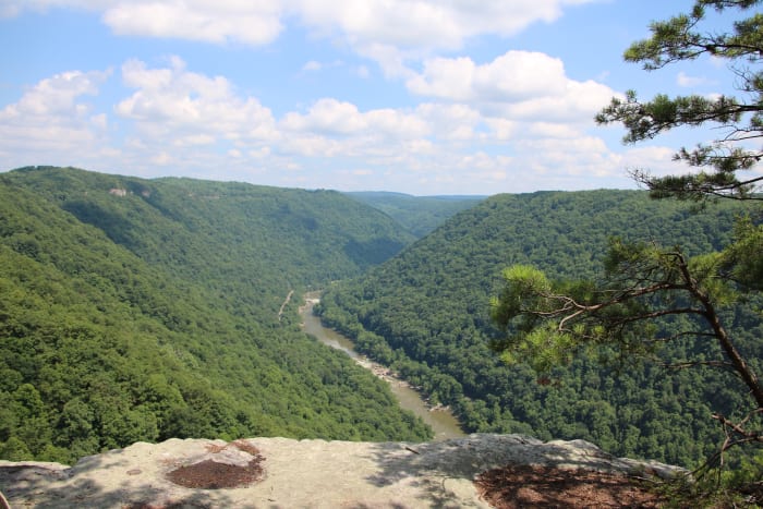 Rocky protrusions jut out from the sides of the gorge, offering stunning views of the entire gorge.