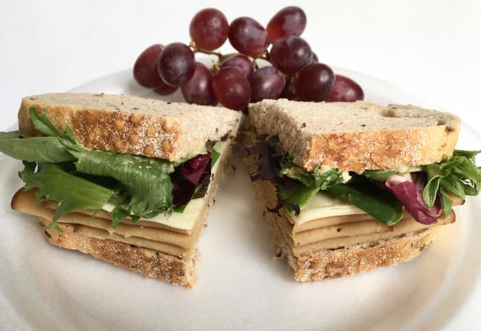 I like bringing sandwiches for a healthy lunch on a road trip because they take little time to make and pack well. Just avoid adding wet condiments or tomatoes to keep them from getting soggy.