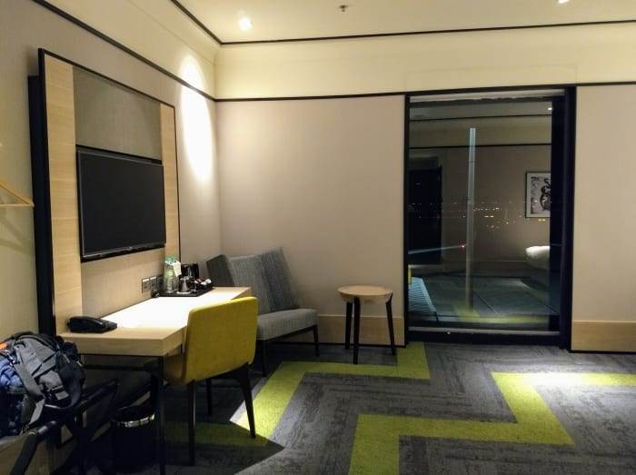 On the left side is the entertainment or work area is on the left. To the right of the pic is the large window overlooking the runways.