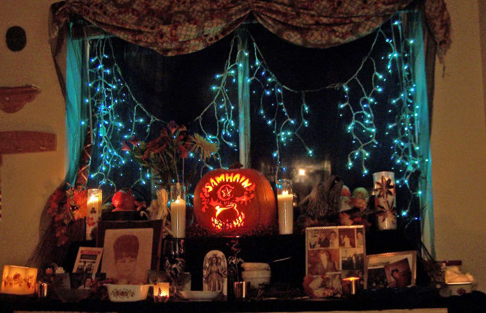 We host a big open house on Samhain, for the living and the dead. We set up a ritual altar for the actual ritual in a different room. But in the dining area we create this shrine to the ancestors for the season to honor them.