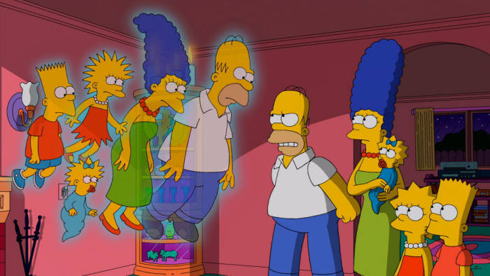 The current Simpsons family, visited by the ghosts of their counterparts from the original series of animated shorts.