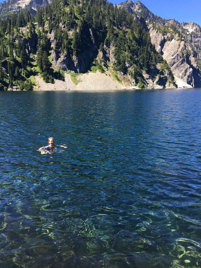 The water is so beautiful it's hard not to give into the temptation to swim, even if there's snow on the opposite shore.