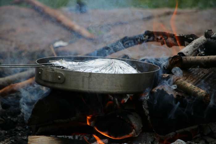 Cook simple meals when camping with little ones. Mountain pies, grilled cheese sandwiches, and pasta are easy to make and have an easy clean-up when mealtime is done.