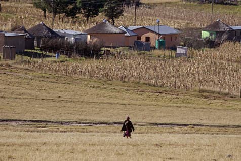 A woman walks to attend the service at the Mqhekezweni Methodist Church, were former South Africa president Nelson Mandela went to church as a child, in Mqhekezweni, South Africa, Sunday, June 16, 2013.