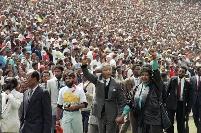 In the Great and Good Times Just After His Release, Winnie and Mandela hand-in=in=hand and waving "power fists to the Crowds