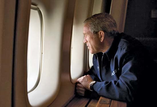 President Bush looking out the window of Air Force One observing the devastation of hurricane Katrina.