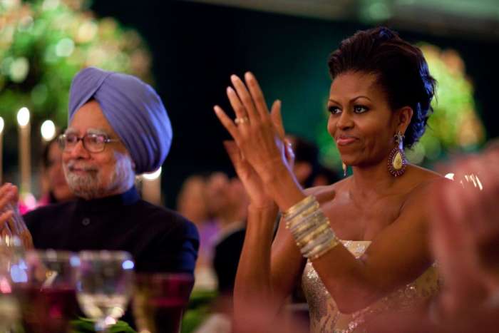 First Lady Michelle Obama claps during the entertainment portion of the State Dinner for Prime Minister Manmohan Singh of India, held in a tent on the South Lawn of the White House, November 24, 2009.