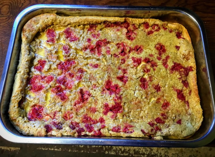Fresh or frozen strawberries (or any kind of berries), may be used with great effect. Place them on top of the batter immediately prior to baking, as they will tend to fall through toward the bottom.