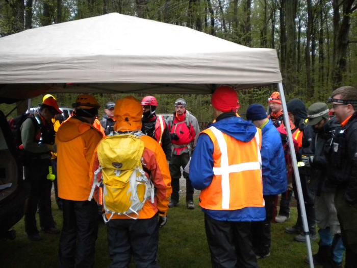 A SAR team briefing on a cold and rainy day for a search that will extend into the night.