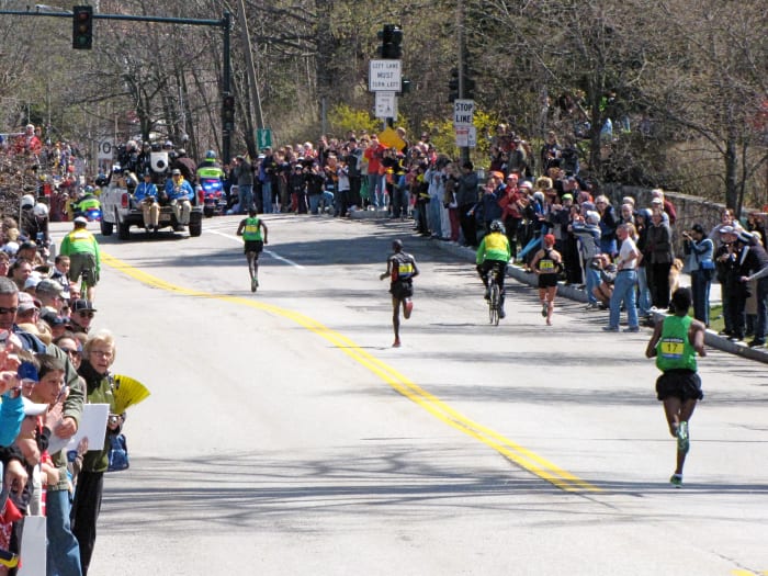 Top 3 men heading up Heartbreak Hill in what would be a record time for winner Geoffrey Mutai of Kenya in 2:03:02 at the 2011 Boston Marathon.