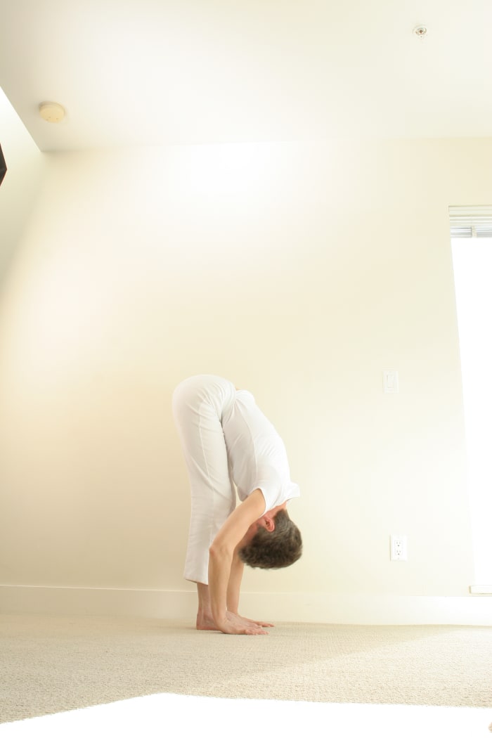 Standing Forward Fold. If this variation is too deep, if you have high blood pressure, or if feel sick or dizzy in this position, use an easy variation with the hands on a chair, the bathtub edge, or the kitchen counter.