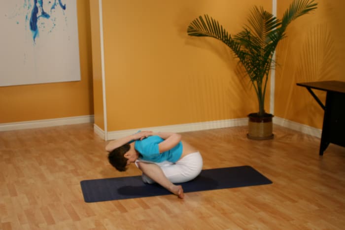 Gomukhasana, or Cow-Faced Posture, is a deep stretch for the gluteals, the Sartorius muscles, and the Iliotibial band (IT band).