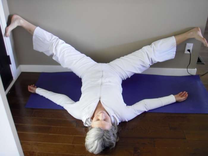 Wide-Legged Legs Up the Wall stretches the backs of the legs (hamstrings) and the inside of the thighs (adductors) to open the hips.