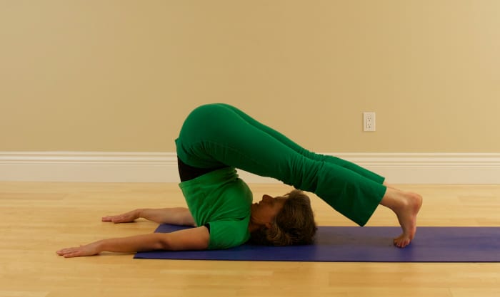 To come down, tower the feet toward the floor behind you, use you hands as brakes, and as you exhale, lower the spine vertebra by vertebra to the floor.