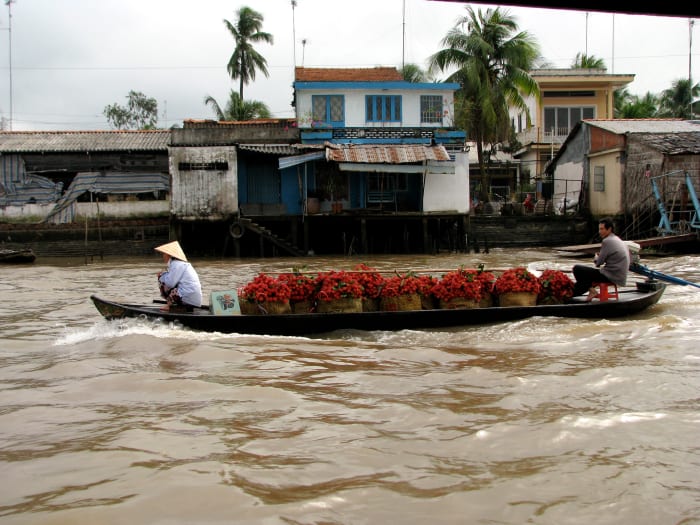 selling the rambutan fruit amongst the various boats, all swapping locally grown fruits and vegetables.