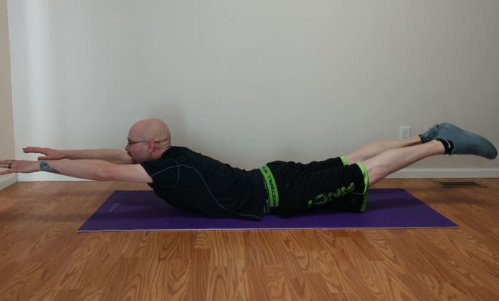 To do the superman exercise, simultaneously raise your arms and legs about 6-15 inches off the floor.
