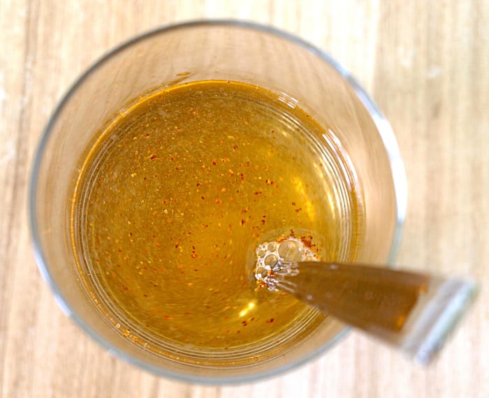 The last step is to add the cayenne pepper and water. I recommend drinking the lemonade fresh—it will taste more acidic after refrigerating.
