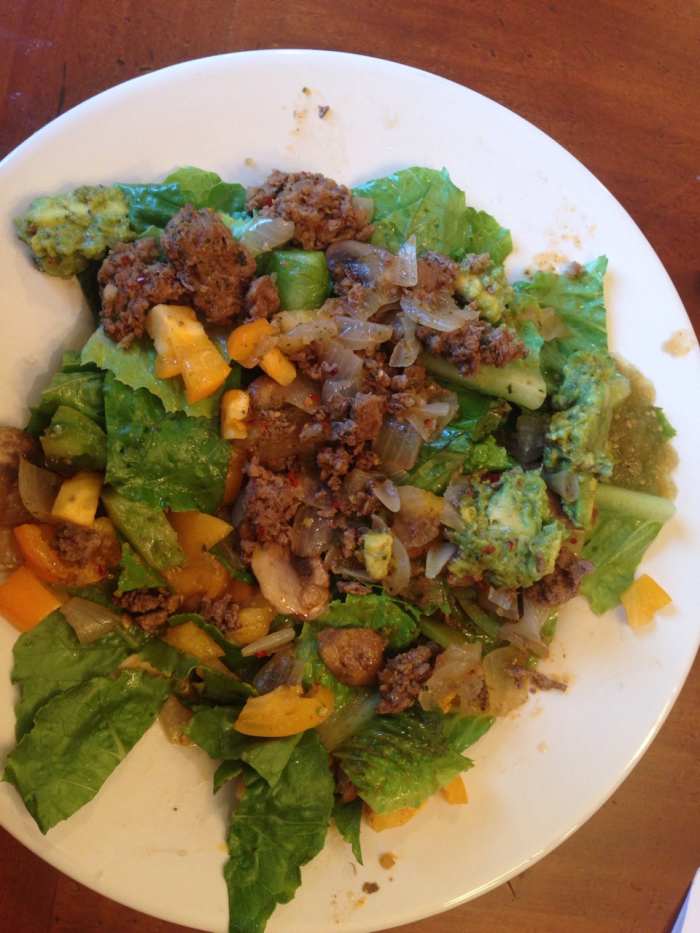 Spicy pepper taco salad: grassfed beef sauteed with mushrooms and onions, leaf lettuce with heirloom tomatoes, simply salsa guacamole, and salsa verde.