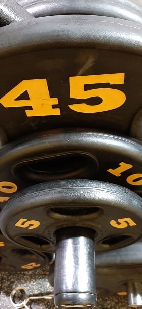 This isn't a loaded barbell. These are weights that have been "put away". Unfortunately, the 45 is "buried" behind the 10 and the 5.