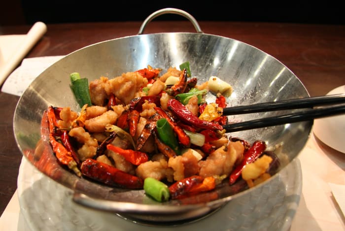No, not all of us cook with woks. It's only used in Chinese cuisine for the most part and no, I don't own one!