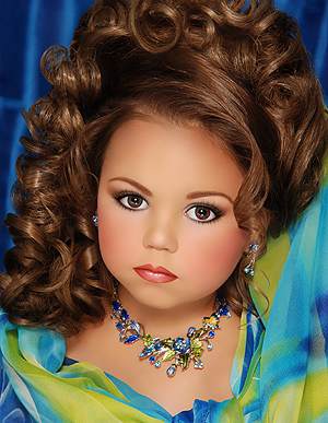 Another Toddlers and Tiaras star. This girl can't be more than five or six. All our girls are going to think they should look like this if we don't knock it off.