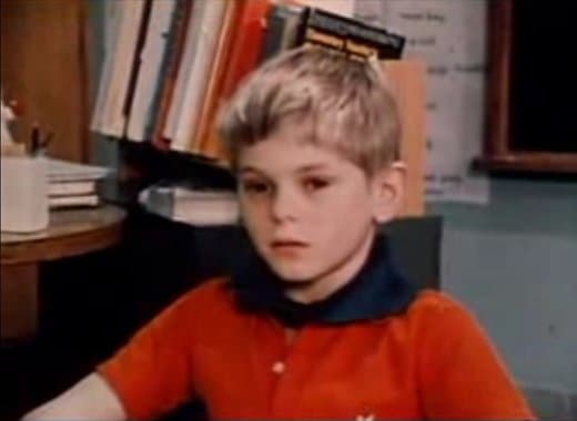 A brown-eyed boy wearing a collar
