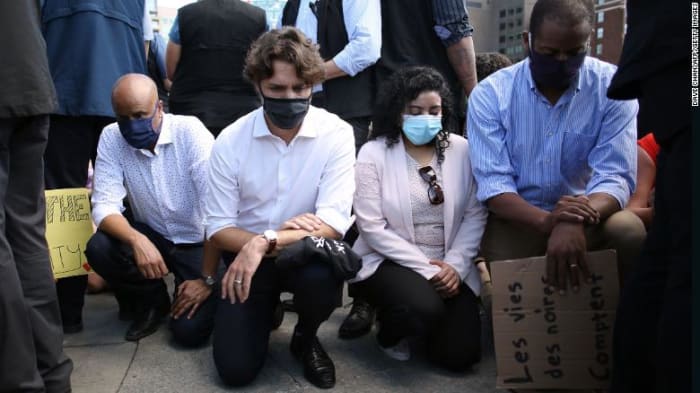 On Parliament Hill, Trudeau and his ministers joined a Black Lives Matter march and took a knee in solidarity with the demonstrators, Jun 2020.