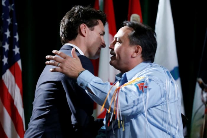Prime Minister Justin Trudeau embraces Assembly of First Nations National Chief Perry Bellegarde at the Assembly of First Nations Special Chiefs Assembly in Gatineau, Quebec, Canada (Dec 6, 2016).