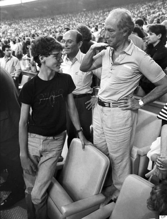 Pierre shows how tall Justin has grown in relation to himself during the seventh inning stretch at the Montreal Expos game in Montreal (Apr 20, 1987).