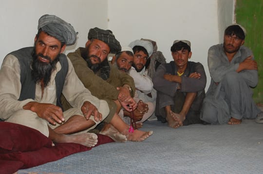 During the Village Medical Outreach, the village elder, Guloojan (left) along with other key leaders met with members of the U.S. forces to discuss the significance of providing medical and humanitarian assistance to the Alizay Kulay village.