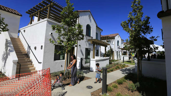 Residents take a stroll through their new complex as city and state officials gather in Vernon on July 25 to celebrate the grand opening of the Vernon Village Park Apartments, a private 45-unit affordable housing development.
