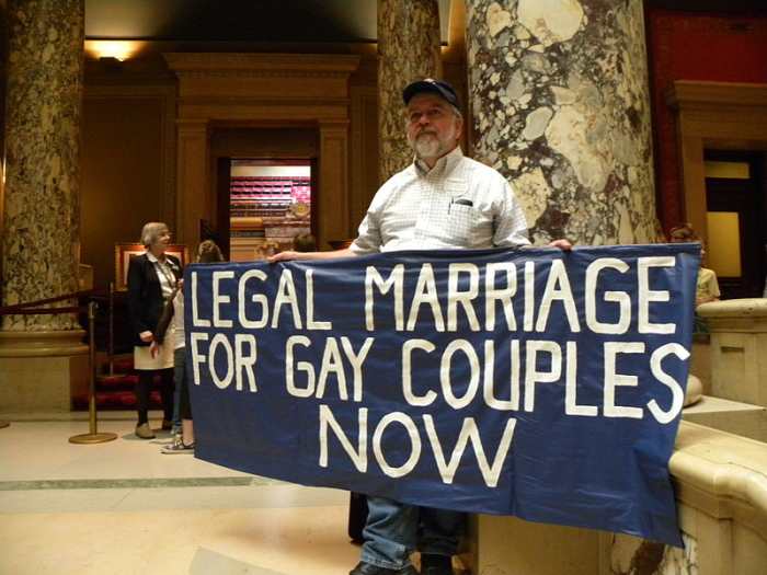 A pro-gay protester outside the Minnesota State Senate.